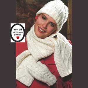 May include: A white knitted set consisting of a beanie, a long scarf, and mittens, all featuring a textured cable knit pattern. The scarf is draped around the neck, and the mittens are held in front. Text on the image reads 40% off on 2 or more patterns.
