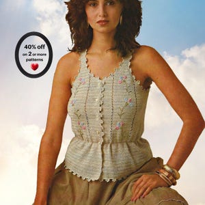 May include: A beige sleeveless crochet top featuring a button-down front, a scalloped neckline, and embroidered floral details in pink and blue. The garment includes a peplum-style waist and vertical open-stitch panels. Text reads: 40% off on 2 or more patterns.