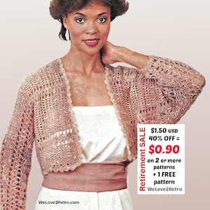 May include: A light pink, open-weave crochet shrug with long sleeves. The shrug has a scalloped edge and is worn over a white dress. The image includes the text "Retirement SALE" and "WeLove2Retro.com".