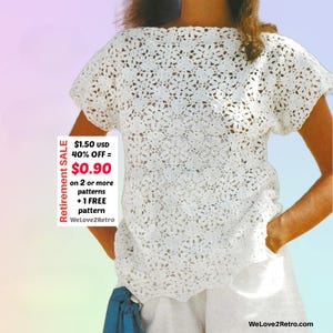 May include: A white, short-sleeved crochet top with a floral pattern. The top has a boat neck and a loose fit. The image includes text that says "Retirement SALE" and "WeLove2Retro.com".