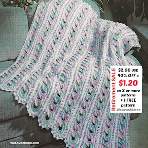 May include: A crocheted blanket in white, pink, and green, draped over a teal sofa. The blanket features a repeating cable stitch pattern with a scalloped edge. The text "Retirement SALE" and "WeLove2Retro" are visible.