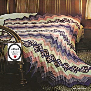 May include: A crocheted chevron blanket featuring horizontal stripes in shades of cream, light pink, lavender, and deep purple. The design incorporates repeating dark purple sections with a floral motif. A white sign reads 40% off on 2 or more patterns.