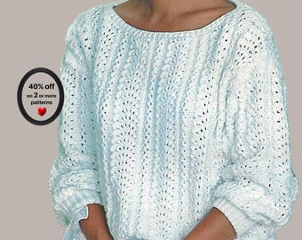 May include: A light blue long-sleeve sweater featuring a vertical knit pattern with openwork details, a wide round neckline, and ribbed cuffs. A black circular badge on the left side displays the text 40% off on 2 or more patterns with a red heart.