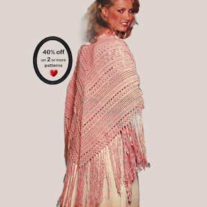 May include: A triangular crochet shawl in a soft peach color featuring a textured stitch pattern with alternating openwork and solid rows. The shawl is finished with long, matching fringe along the bottom edges. Text reads: 40% off on 2 or more patterns.
