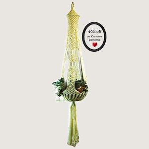 May include: A pale yellow macrame plant hanger featuring intricate knotted patterns, a tapered top, and a long fringe at the base. The hanger holds a small green plant. A black oval graphic displays the text 40% off on 2 or more patterns.