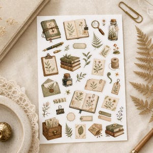 May include: A sheet of vintage-style stickers featuring botanical illustrations. The stickers include open books, journals, a magnifying glass, a pen, and sprigs of greenery in shades of green, brown, and beige.