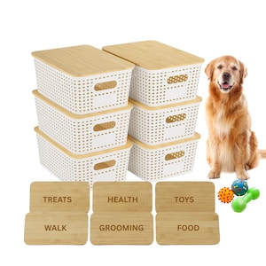 May include: Six white plastic storage baskets with bamboo lids, ideal for pet supplies. The baskets are rectangular with a perforated design and handles. Wooden labels read "Treats", "Health", "Toys", "Walk", "Grooming", and "Food". A golden retriever sits nearby.