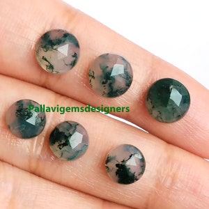 May include: Five round, faceted, green and white agate cabochons. The cabochons have a mottled green and white pattern.