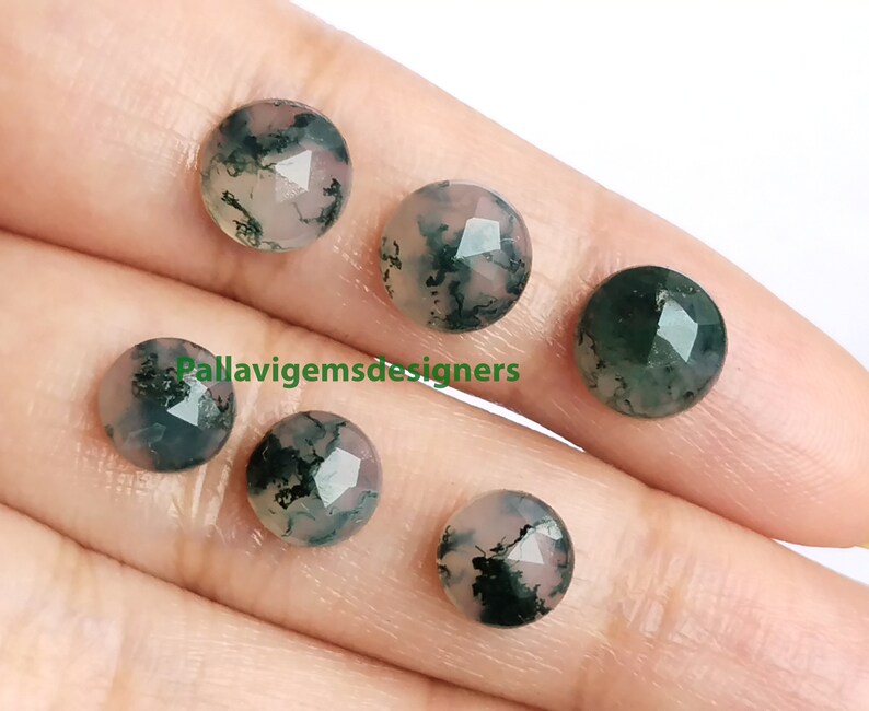 May include: Five round, faceted, green and white agate cabochons. The cabochons have a mottled green and white pattern.