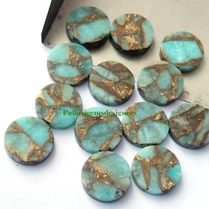 May include: Twelve round, turquoise and gold, gemstone cabochons. The cabochons are approximately 10mm in diameter and have a mottled, marbled appearance.