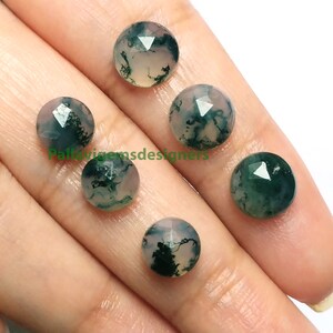 May include: Five round, faceted, moss agate cabochons in shades of green and white. The stones are approximately 10mm in diameter.