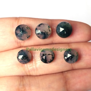 May include: Six faceted, round, green and pink agate gemstones with black dendritic inclusions. The stones are approximately 10mm in diameter.