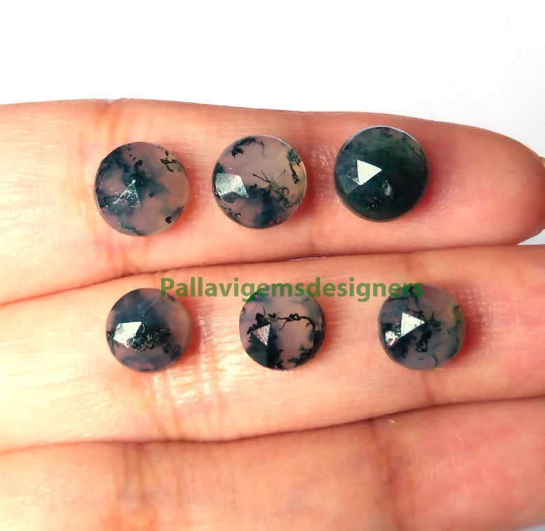 May include: Six faceted, round, green and pink agate gemstones with black dendritic inclusions. The stones are approximately 10mm in diameter.