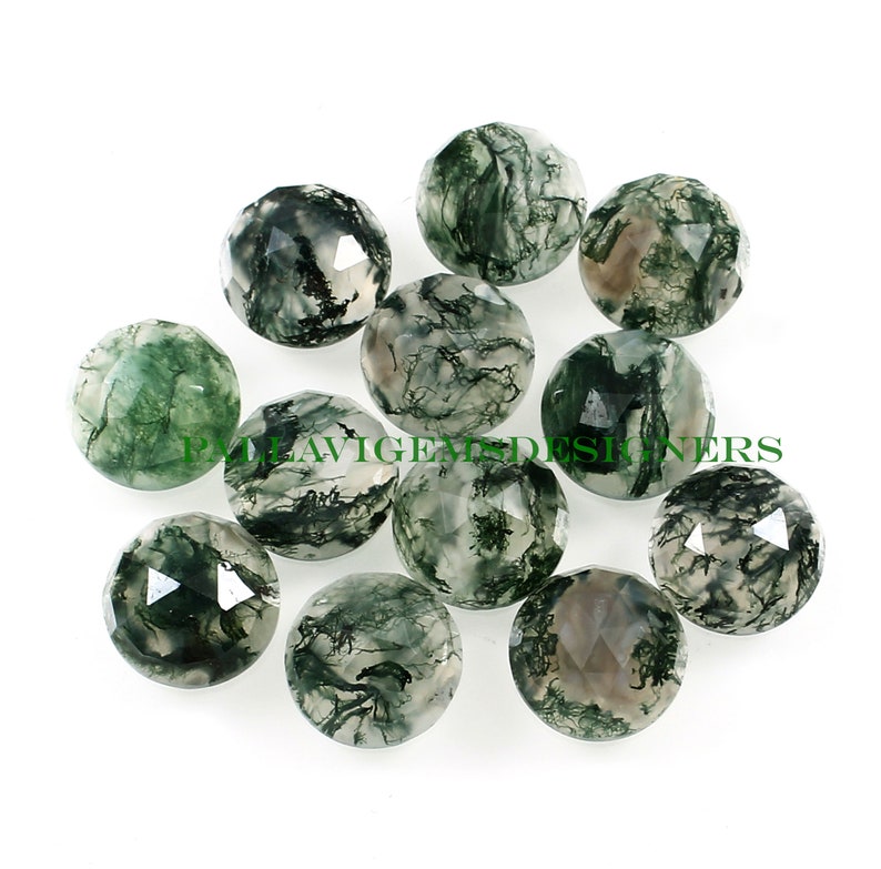 May include: A collection of 10 green moss agate cabochons, each with a unique pattern of green and white. The cabochons are faceted and have a smooth, polished finish.