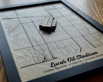 May include: A framed wooden map of Indianapolis, Indiana with a 3D model of Lucas Oil Stadium. The text "Lucas Oil Stadium Indianapolis, Indiana, United States since 2008" is printed below the map.