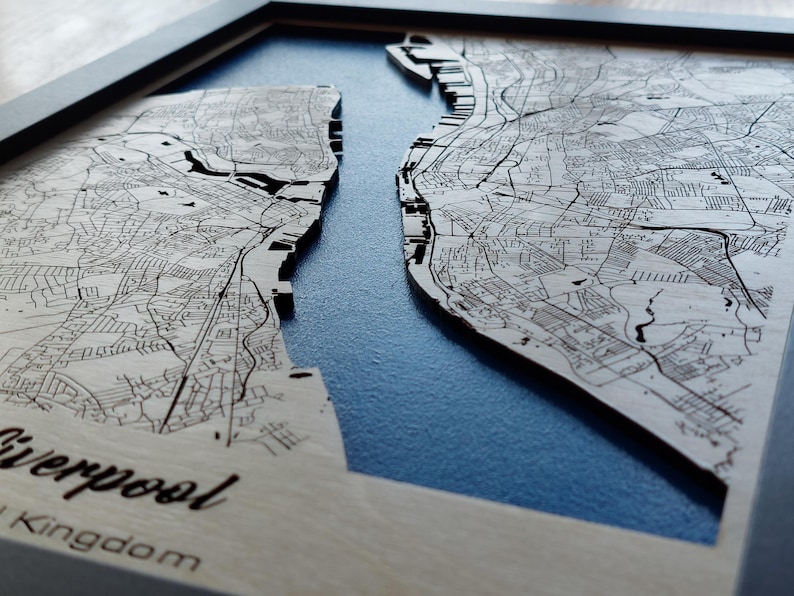Pu&ograve; includere: Una mappa di legno di Liverpool, Regno Unito, con sfondo blu. La mappa &egrave; in rilievo e mostra le strade e le vie d'acqua della citt&agrave;.