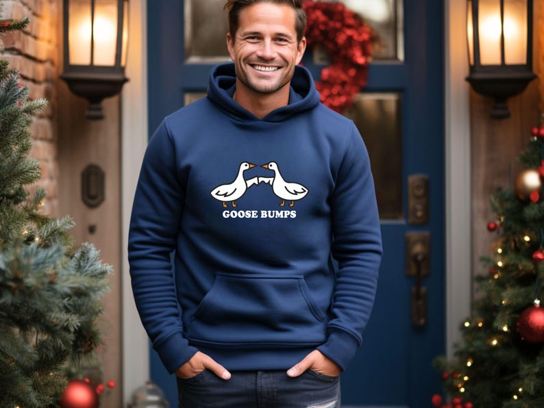 May include: A navy blue hoodie with a white graphic of two geese facing each other with the text "GOOSE BUMPS" underneath.