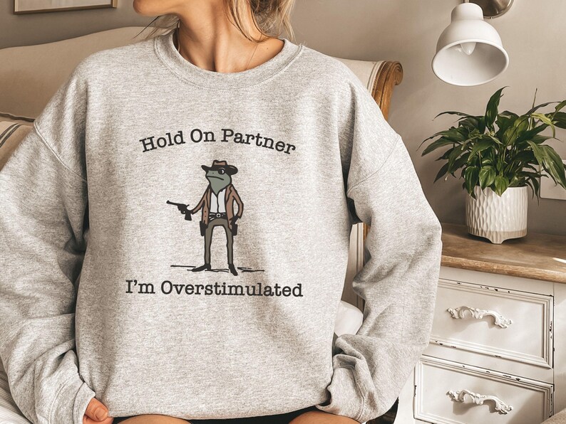 Hold On Partner Im Overstimulated Shirt, Cowboy Frog Sweatshirt, Unhinged Tshirt, Weirdcore Outfits, Gen Z Sweater, Funny Meme Hoodie Tee, Cowgirl Frog Women Sweatshirts, Western Frogs Girl Party Hoodies, Frog Gun Vacation Shirts,Holiday Cowgirls Tee