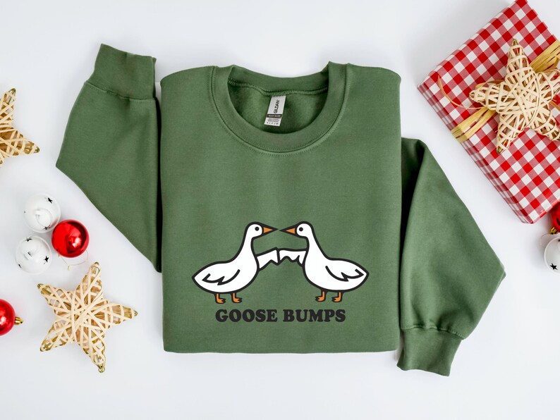 May include: A green sweatshirt with a white goose design and the text "GOOSE BUMPS".