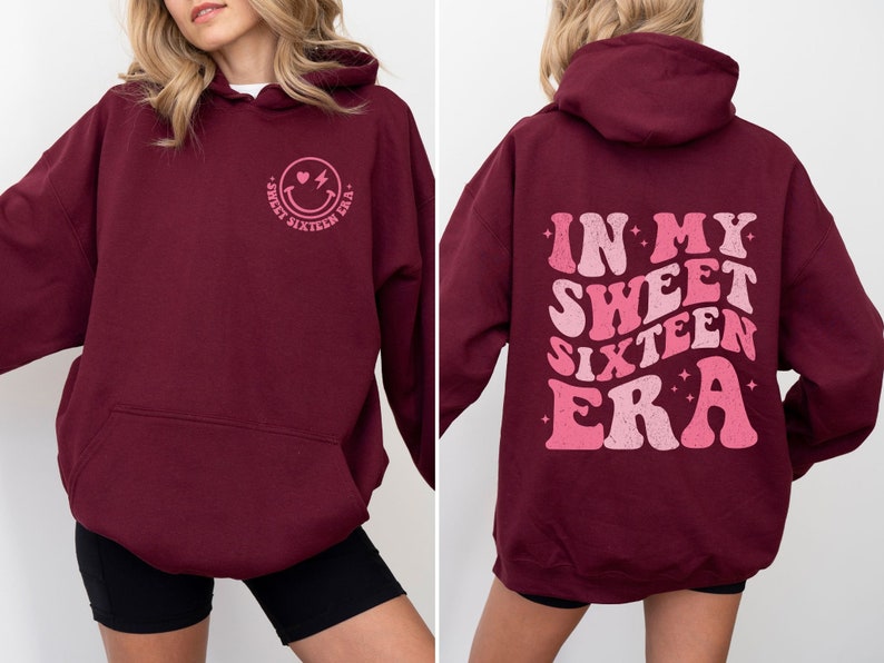 May include: Burgundy hoodie with a pink smiley face graphic on the front and "In My Sweet Sixteen Era" text on the back.