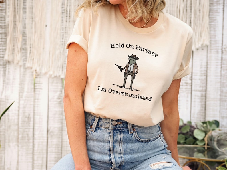 Hold On Partner Im Overstimulated Shirt, Cowboy Frog Sweatshirt, Unhinged Tshirt, Weirdcore Outfits, Gen Z Sweater, Funny Meme Hoodie Tee, Cowgirl Frog Women Sweatshirts, Western Frogs Girl Party Hoodies, Frog Gun Vacation Shirts,Holiday Cowgirls Tee