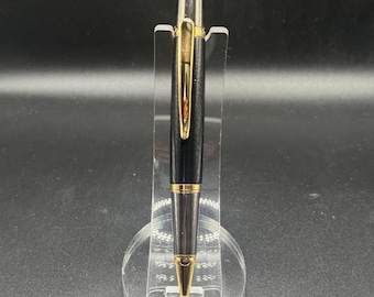 Black bodied twist pen with gold and chrome accents