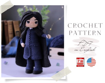 May include: Crochet pattern PDF in English for a blue crocheted amigurumi doll with black hair and a wand. The doll is wearing a long black robe and black pants. The pattern is available in English and is a digital download.