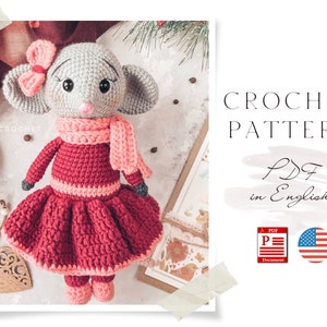 May include: Crochet pattern PDF in English for a cute grey and pink crocheted mouse wearing a red dress and a pink scarf. The pattern includes instructions for making the mouse, dress, and scarf.