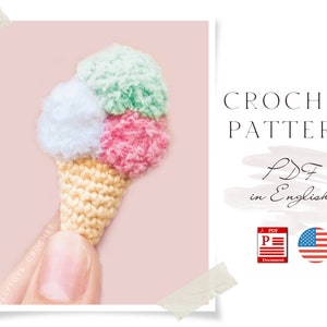 May include: Crochet pattern for a miniature ice cream cone with three scoops of ice cream in green, pink, and white. The pattern is available as a PDF in English.
