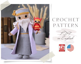 May include: Crochet pattern PDF in English for a purple and grey crocheted doll with a white beard and a red and yellow crocheted bird in its hand. The pattern is available in PDF format and is written in English.