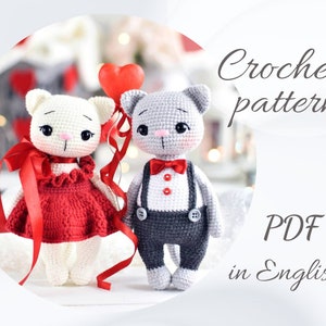 May include: Crochet pattern PDF in English for two adorable amigurumi cats. One cat is white with a red dress and a red bow, the other is gray with a black and white outfit and a red bow tie.