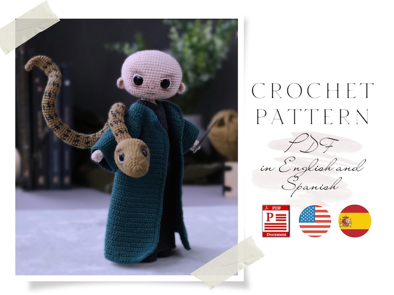 May include: Crochet pattern PDF in English and Spanish for a green crocheted amigurumi doll with a snake wrapped around its arm. The doll has a light brown face with black eyes and a black mouth. The snake is brown with a light brown head. The pattern is available in PDF format.