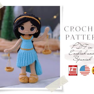 May include: Crochet pattern for a blue and gold amigurumi doll with scales. The pattern is available in PDF format in both English and Spanish.