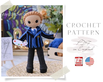 May include: Crochet pattern for a boy doll wearing a blue and black striped jacket, black pants, and holding a paintbrush and a palette. The pattern is available in PDF format and is written in English. The image also includes a US flag.