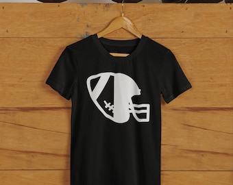 May include: Black t-shirt with a white graphic of a football and helmet.