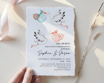 May include: A gender reveal party invitation with a watercolor illustration of two storks carrying a baby boy and a baby girl. The text reads "Girl or Boy? Join us for a gender reveal honoring Sophie & Jason Saturday, November 15, 2022 4PM-6PM 23213 Ridge Rd. Solon OH 45456 RSVP DAGA at 123 235 231 by 10/12 Registered at Amazon & Target"