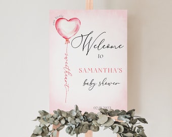 May include: Pink welcome sign with a watercolor heart balloon and the text "our little sweetheart" and "Welcome to Samantha's Baby Shower 02.11.2023".