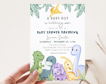 May include: A baby shower invitation with a dinosaur theme. The invitation features a blue, green, yellow, and purple dinosaur illustration with the text "A baby boy is hatching soon. Join us for a baby shower honoring Lauren Smith. Saturday, December 24, 6 PM. The Anderson Home 23213 Ridge Rd. Solon OH 45456. RSVP to Daga at 123 123 123. registered amazon.com"