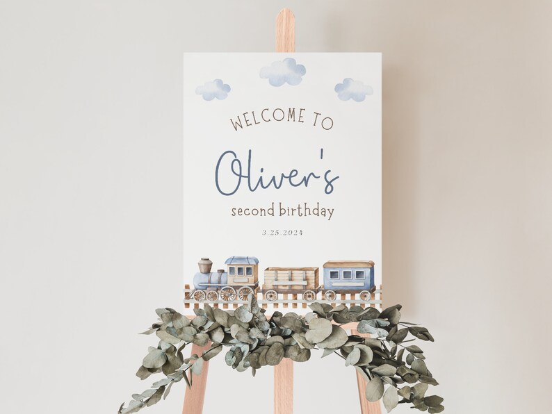 May include: A blue and white watercolor train with clouds and the text "Welcome to Oliver's second birthday 3.25.2024" on a white background.