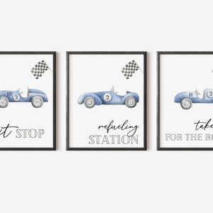 May include: Three watercolor illustrations of blue race cars with checkered flags. The text on the prints reads "pit stop", "refueling station", and "take one for the road".