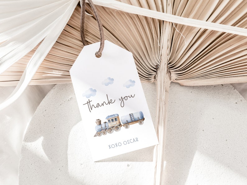 May include: A white thank you tag with a blue and brown train illustration. The tag says "Thank you" and "XOXO Oscar".