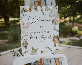 May include: Welcome to Joanna & Michael's Gender Reveal sign with a watercolor design featuring woodland animals, baby clothes, and eucalyptus leaves. The date 10.15.2021 is printed on the sign.