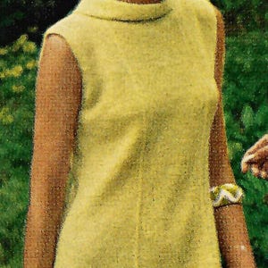 May include: A vintage image of a woman wearing a sleeveless, pale yellow dress with a high neckline. The dress is knee-length. She is wearing a bracelet. The background is a blurred green, suggesting an outdoor setting.