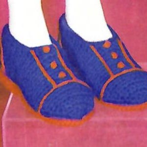 May include: A pair of blue knitted slippers with orange trim and three buttons on each slipper.