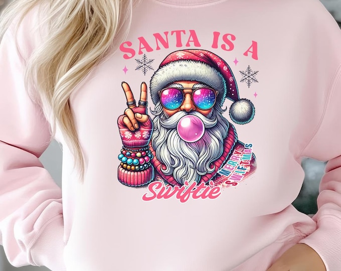 Featured listing image: Santa Is A Swiftie T-shirt, Bubblegum Santa T-shir, Christmas Swifties Shirt, Swiftie Fan Christmas Gift, Christmas Sweatshirt, Funny Santa