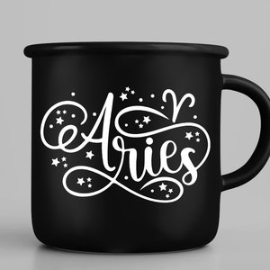May include: Black ceramic mug with a white design that says "Aries" with stars and the astrological symbol for Aries.