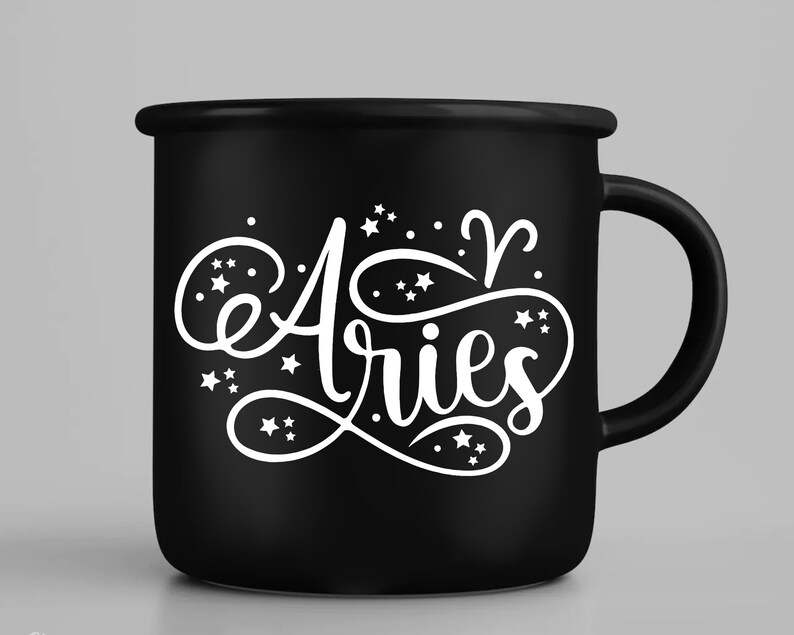 May include: Black ceramic mug with a white design that says "Aries" with stars and the astrological symbol for Aries.