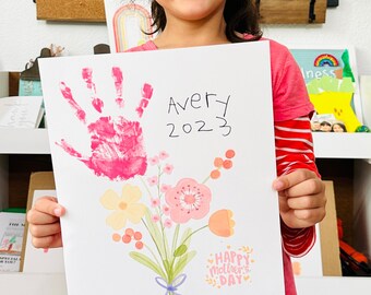 May include: A white card with a pink handprint, a bouquet of flowers, and the text "Avery 2023" and "Happy Mother's Day".