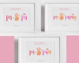 May include: Three white picture frames with pink and orange handprint art. The frames contain the words "Mom", "Mommy", and "Mia" with a handprint in the center of each word. Each frame includes the quote "If I know what love is, it is because of you."