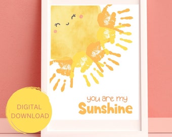 May include: A printable art print with a yellow sun made of handprints. The sun has a smiling face and the text "you are my sunshine" is below it.